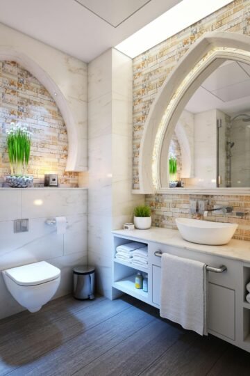 Elegant modern bathroom with marble tiles, ambient lighting, and stylish decor.
